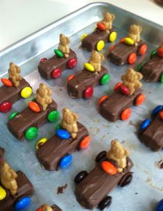 chocolate candies with teddy bears and candy in them on a baking sheet, ready to be eaten