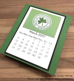 a green and white calendar on a wooden table