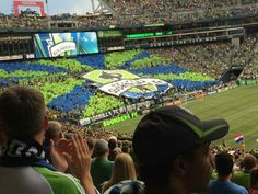 a stadium filled with people watching a football game