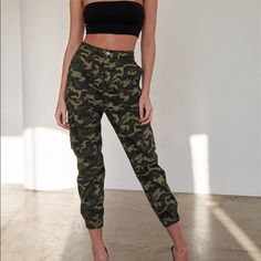 Pants Features: Camouflage Print, Green, Black, Light Green, Brown, High Waisted, Semi-Stretchy, Elastic Leg Hem, Unlined, Front Pockets, Two Big Cargo Pockets, Silver Hardware, Matching Belt.Item Measurements: Length: 38" Waist: 26"Model Is 5’8" And Wearing Size Small (Waist: 23", Bust: 32c, Hips: 34") True To Size Stretch Military Camouflage Bottoms, Stretch Camouflage Bottoms With Pockets, Fitted Camouflage Military Pants, Fitted Camouflage Bottoms For Fall, Fitted Camouflage Trousers, High Waist Camouflage Military Bottoms, Camouflage Bottoms With Elastic Waistband For Fall, Combat Style Camouflage Bottoms For Fall, Fitted Camouflage Pants For Fall