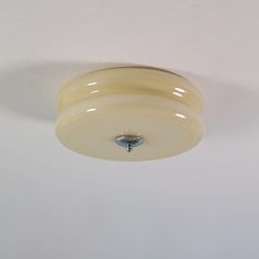 a white ceiling light hanging from the ceiling