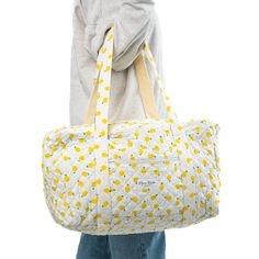 Introducing the Lemonade Large Duffel Bag - a spacious carry-all with a  convenient zippable front pocket, designed to make a statement wherever life takes you. The quilted exterior features a beautiful lemon-themed pattern, complemented by a classy striped green interior. Perfect for extended trips, weekend getaways, or as a chic gym companion, the Lemonade Large Duffel Bag effortlessly combines fashion and functionality. Size: 20" x 12" x 11" Chic Gym, Green Interior, Childrens Rugs, Dash And Albert, Quilted Sham, Bedding Basics, Green Interiors, Duffel Bag Travel, Linen Throw