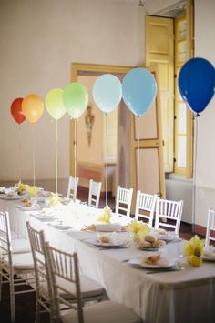 a long table with plates and balloons on it