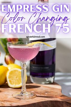 a pink cocktail in a coupe glass on a cutting board with lemons next to it