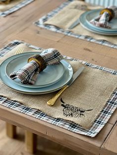 the table is set with blue plates and plaid napkins