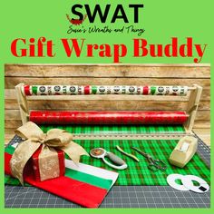 the gift wrap buddy is on display with scissors and tape