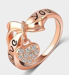 This 18k rose gold plated ring is ready to ship. It fits a size 7 / size 8 and has the inscription "LOVE YOU" in black enamel on the ring. The heart shaped locket charm has Austrian Crystals on it. This ring makes a great Valentines Day gift for yourself or someone special. Available in Size 7 , Size 8 and Size 9 only ************************************************************************************ Thank you for visiting our shop! If you have any questions regarding this item, please don't he Rose Gold Heart Ring, Word Ring, Rose Gold Plated Ring, Gold Heart Ring, Knuckle Ring, Letter Ring, Bow Ring, Heart Shaped Rings, Rose Gold Heart