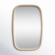 a mirror that is made out of rope and wood with beading on the edge