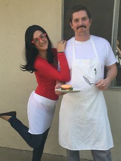 a man and woman dressed up in costumes for halloween, standing next to each other