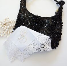 two pieces of black and white lace with pearls