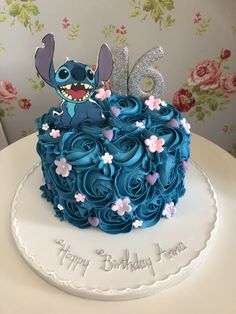 a birthday cake decorated with blue icing and flowers