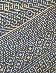 a blue and white rug on the floor