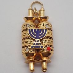 "Vintage 14k (.585) yellow gold figural charm or pendant in filigree designs, featuring Judaic Torah scroll holder, decorated with blue enamel. The three of four red cabochon accents are missing. This darling charm is 1 1/4\" long, 5/8\" wide, weighing 4.7 grams. EA4883" Traditional Gold Jewelry Souvenir, Traditional Gold Souvenir Jewelry, Traditional Gold Jewelry For Souvenir, Traditional Gold Jewelry As Souvenir, Gold Filigree Jewelry With Enamel, Hanukkah Pendant Jewelry, Gold Enamel Jewelry Souvenir, Torah Scroll, Asoiaf Art