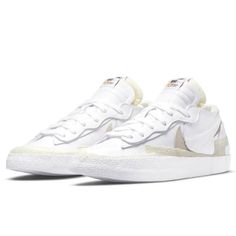 The Sacai X Nike Blazer Low ‘White Patent’ Reimagines The Vintage Silhouette With Designer Chitose Abe’s Deconstructed Aesthetic. The Upper Is Crafted From Glossy White Patent Leather With An Exposed-Foam Collar And A Pair Of Overlapping Swooshes, One In Grey Suede, The Other In White Matte Leather. Eyestays And Tongues Are Similarly Doubled Up, While Multiple Layers Of Textured Rubber Reinforce The Toe, Midfoot And Heel. Dual Nike And Sacai Branding Decorates The Sockliner. Underfoot, A Traditi Classic White Custom Nike Sneakers, Classic White Sneakers With Gum Sole, Nike White High-top Sneakers With Vulcanized Sole, White Nike High-top Sneakers With Vulcanized Sole, Nike White High-top Sneakers With Gum Sole, White Mid-top Skate Shoes With Rubber Waffle Outsoles, White Basketball Shoes With Rubber Waffle Outsoles For Streetwear, Classic White Basketball Shoes With Contrast Sole, White Lace-up Skate Shoes With Rubber Waffle Outsoles