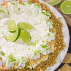 a pie with limes and whipped cream on top