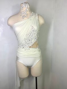 a mannequin wearing a white bodysuit with silver sequins on it