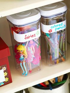 two plastic containers filled with toys on top of a shelf