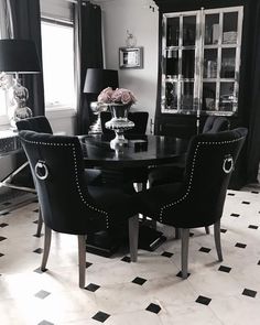 a black and white dining room table with chairs