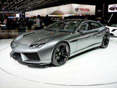 a silver sports car on display at an auto show