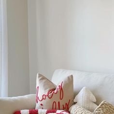 a white couch with red and white pillows