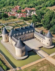 an aerial view of a castle surrounded by trees