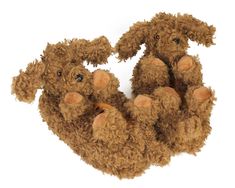 three stuffed animals sitting next to each other on a white surface and one is brown