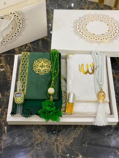 an open box containing jewelry and other items on a table with marble counter top in the background