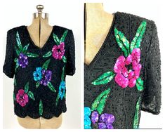 "DETAILS. bright | glam | floral darling 1980's top. vintage black and multi-color sequin and beaded top. floral motif. slight shoulder pads. keyhole hook-eye closure at back. scalloped hem. v-neck.  great vintage condition. this top is from my private collection. MEASUREMENTS. BUST: up to 42\" WAIST: up to 40\" HIPS: -- LENGTH: 25\"  SHOULDERS: 17\" SLEEVES: 11\" FABRIC: sequins/beads LABEL:  Visit the shop: https://www.etsy.com/shop/EvesAppleVintage << you can find most of my private collectio Glam Disco, Vintage Flapper Dress, Beaded Top, Top Floral, Top Vintage, Sequin Beading, Dress Top, Sequin Top, Scalloped Hem