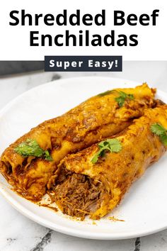 shredded beef enchiladas on a white plate