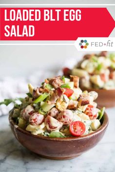 two bowls filled with salad sitting on top of a counter next to a red sign that says loaded blt egg salad