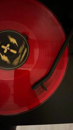 a red record player sitting on top of a table