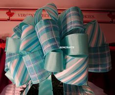 "Turquoise/Seafoam Stripe Wired Ribbon Christmas Tree Topper Bow.  12\" wide.  Six (6) six (6) foot detachable tails.  40 loops.  Made with three (3) different kinds of wired ribbon:  2-1/2\" Turquoise/Seafoam Diagonal Stripe; 2-1/2\" Turquoise Plaid; and 1-1/2\" Solid Seafoam. This bow has a \"beachy vibe\" to it.  The colors are very vibrant--pictures do not do it justice. NOTE:  Each bow is handmade so no two are exactly the same. I use only the highest quality materials on all of my creation Christmas Tree Toppers For Small Trees In Teal, Beach Christmas Tree Topper, Turquoise N Gold Ribbon Tree Topper, Coastal Tree Topper, Coastal Angel Tree Topper, Christmas Tree Topper Bow, Tree Topper Bow, Small Wreaths, Beach Color