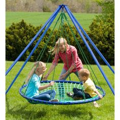 three children playing in a blue and green play ground