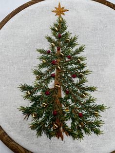 a cross stitch christmas tree on a white background