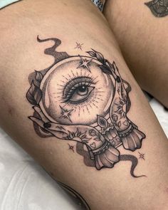 a woman's thigh with an all seeing eye tattoo on it