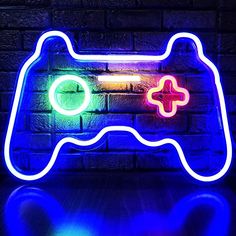 a neon video game controller is shown in front of a brick wall