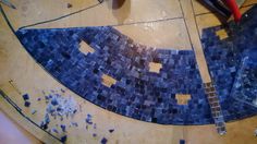 the blue mosaic tiles are being worked on