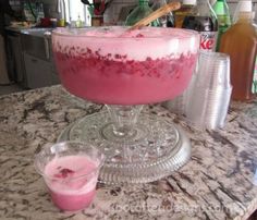 a pink drink is sitting on a table