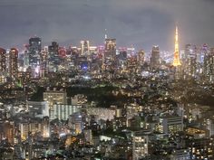 the cityscape is lit up at night with bright lights in the buildings and skyscrapers