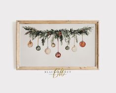 christmas ornaments hanging from the side of a wooden frame