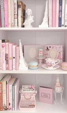 the shelves are filled with books, figurines, and other items in pastel colors