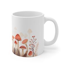 a white coffee mug with mushrooms and plants on the inside, in front of a white background