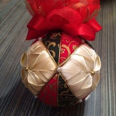 an ornament with red ribbon on top of it