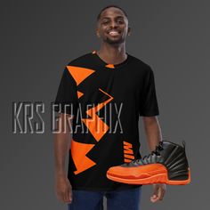 Step up your sneakerhead game with our shirt to match the Jordan 12 Brilliant Orange! 🌟👟 Whether you're a die-hard fan of the iconic Jordan brand or simply love rocking fresh kicks, this shirt is the perfect addition to your sneakerhead wardrobe. With its premium knit mid-weight jersey and jagged graphics inspired by the Jordan 12 Brilliant Orange colorway, you're guaranteed to turn heads and catch eyes. Crafted from a soft, comfortable cotton touch polyester jersey, this shirt is perfect for everyday wear. With its four-way stretch fabric that stretches and recovers on the cross and lengthwise grains, it provides a comfortable and flattering fit for any body type. The regular fit ensures that it's easy to wear and versatile enough to pair with any outfit. The Jordan 12 Brilliant Orange Sports Fan T-shirt, Pre-shrunk, Casual Graphic T-shirt For Sports Events, Casual Tops With Graphic Design For Sports Events, Casual Graphic Top For Sports Events, Sports Fan T-shirt With Logo Print For Streetwear, Orange Graphic T-shirt For Streetwear, Orange Graphic Design T-shirt For Streetwear, Graphic Print Athletic Tops For Streetwear, Jordan 12