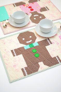 two placemats with teddy bears on them, one has a cup and saucer