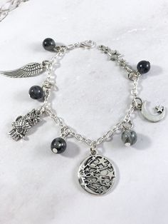 This Nyx themed charm bracelet is the perfect accessory to showcase your love for the Greek myths in a subtle way. Charms included: Wing Owl Night Sky Moon Star Cluster 5 labradorite gemstone beads are also included in between each charm. Comes in three sizes: Small: 6.5 inches (with extra rings at the end to expand up to 7.5 inches.) Standard: 7.5 inches Large: 8.5 inches Secures with a lobster clasp. Bracelet and charms are made with zinc alloy and beads are natural gemstones. All materials ar Metal Charm Bracelet With Moon Charm As A Gift, Nox Goddess, Goddess Of Night, Goddess Greek, Greek Mythology Jewelry, Owl Night, Mythology Jewelry, Goddess Jewelry, Star Cluster