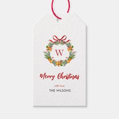 a christmas gift tag with the letter w on it and holly wreaths in the center