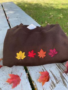 Vibrant embroidery of maple leaves... leaving you warm and cozy :)  The sweatshirts are unisex adult sizing, and all of my items are machine washable!  Please let me know if you have any questions! Thank you <3 *Pictured is a dark brown crewneck sweatshirt Brown Crewneck, Dinner Decor, Dinner Decoration, River Falls, Fall Dinner, Embroidered Crewneck, Maple Leaves, Maple Leaf, Warm And Cozy