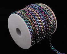 a spool of multicolored metallic wire on a black background