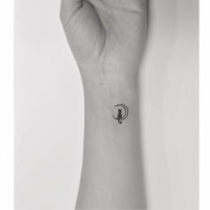 a person's wrist with a small tattoo on it